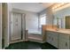 Primary bathroom with large soaking tub, glass shower and double vanity at 12015 Harbour Town Pkwy, Fayetteville, GA 30215
