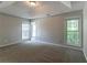 Primary bedroom with multiple windows and neutral paint at 12015 Harbour Town Pkwy, Fayetteville, GA 30215
