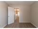 Bedroom with neutral walls and carpet flooring, conveniently located near the hallway at 12015 Harbour Town Pkwy, Fayetteville, GA 30215