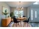 Formal dining room with stylish decor, chandelier lighting, and view to entryway at 12015 Harbour Town Pkwy, Fayetteville, GA 30215