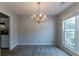 Traditional dining room with chandelier lighting and large window overlooking the outdoor view at 12015 Harbour Town Pkwy, Fayetteville, GA 30215