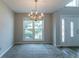 Bright dining room featuring a decorative chandelier and an entrance doorway at 12015 Harbour Town Pkwy, Fayetteville, GA 30215