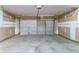 Spacious garage with a roll-up door and unfinished drywall ready for personalization at 12015 Harbour Town Pkwy, Fayetteville, GA 30215