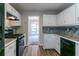 Kitchen featuring white cabinets, modern appliances, and a stylish backsplash at 12015 Harbour Town Pkwy, Fayetteville, GA 30215