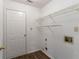 Functional laundry area with wood-look flooring, white walls, and built-in wire shelving at 12015 Harbour Town Pkwy, Fayetteville, GA 30215