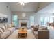 Comfortable living room with fireplace, ceiling fan and view into the formal dining area at 12015 Harbour Town Pkwy, Fayetteville, GA 30215