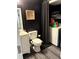 Bathroom with vanity, toilet, washing machine and black walls at 210 Mill Creek Pl, Roswell, GA 30076