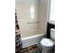 Bathroom with tan shower, toilet, gray floors, and bear themed curtain at 210 Mill Creek Pl, Roswell, GA 30076