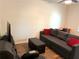 Comfortable bedroom featuring a sofa, desk, television, and cozy seating area at 210 Mill Creek Pl, Roswell, GA 30076