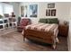 Bedroom with posters, bed, wood floor, and comfy chair at 210 Mill Creek Pl, Roswell, GA 30076