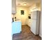 Cozy kitchen with white cabinets, stainless steel appliances, and wood floors at 210 Mill Creek Pl, Roswell, GA 30076