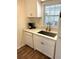 Bright kitchen with white cabinets, granite countertop and stainless sink at 210 Mill Creek Pl, Roswell, GA 30076