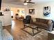 Bright and inviting living room featuring hardwood floors, a fireplace, and stylish decor at 210 Mill Creek Pl, Roswell, GA 30076