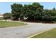 Street view with trees and some apartments in the background at 210 Mill Creek Pl, Roswell, GA 30076
