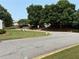 Manicured lawns and mature trees surround the community street, offering a serene and inviting neighborhood setting at 210 Mill Creek Pl, Roswell, GA 30076