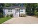 Charming single-story home with a well-manicured lawn and a concrete driveway leading to the front door at 462 Center Hill Ave, Atlanta, GA 30318