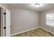 Cozy bedroom featuring new floors, neutral paint, and natural light from a window at 568 Mcwilliams Se Rd, Atlanta, GA 30315