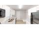 Modern kitchen with white cabinets, gray countertops, and stainless steel appliances at 568 Mcwilliams Se Rd, Atlanta, GA 30315