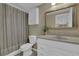 A full bathroom features an updated vanity, large mirror, shower, and toilet at 1304 Swallows Walk, Grayson, GA 30017