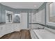 Stylish bathroom featuring a separate tub and shower, white cabinets, and modern design at 1304 Swallows Walk, Grayson, GA 30017