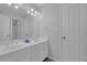 A bathroom features a double sink vanity with updated fixtures and two doors at 1304 Swallows Walk, Grayson, GA 30017