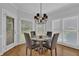 A breakfast nook with a glass table, four chairs, a chandelier and lots of natural light at 1304 Swallows Walk, Grayson, GA 30017