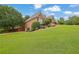 Spacious home boasts a lush green lawn with mature trees and manicured shrubs creating great curb appeal at 1304 Swallows Walk, Grayson, GA 30017