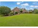 Charming brick home with a well-manicured lawn and colorful landscaping creating inviting curb appeal at 1304 Swallows Walk, Grayson, GA 30017