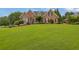 Charming brick home features a well manicured front yard and mature landscaping at 1304 Swallows Walk, Grayson, GA 30017