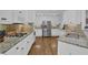 Kitchen featuring stainless steel appliances, white cabinets, granite countertops, and hardwood floors at 1304 Swallows Walk, Grayson, GA 30017