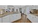 Open kitchen with white cabinets, granite countertops and stainless appliances overlooking breakfast area at 1304 Swallows Walk, Grayson, GA 30017