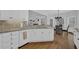 Kitchen featuring white cabinets, granite countertops, a breakfast bar and a view to the dining area at 1304 Swallows Walk, Grayson, GA 30017