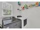 Convenient laundry room with modern washer and dryer units and ample storage at 1304 Swallows Walk, Grayson, GA 30017