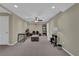 A basement living room features recessed lighting, neutral walls, and brown carpet at 1304 Swallows Walk, Grayson, GA 30017