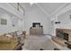 Bright living room with a brick fireplace, plush leather couch, and high ceilings at 1304 Swallows Walk, Grayson, GA 30017