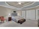 The main bedroom features a trey ceiling, a neutral color palette, and an abundance of natural light at 1304 Swallows Walk, Grayson, GA 30017