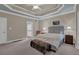 The main bedroom features a large bed, trey ceiling, ensuite bathroom, and ample light at 1304 Swallows Walk, Grayson, GA 30017