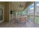 Relaxing screened porch with a ceiling fan, TV, and dining table for enjoying outdoor living at 1304 Swallows Walk, Grayson, GA 30017