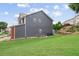 Backyard featuring a well maintained lawn and an exterior view of the side of the home at 1657 Bradmere Ln, Lithia Springs, GA 30122