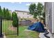 Fenced backyard featuring evergreens, a shed, and ample space for outdoor activities at 1657 Bradmere Ln, Lithia Springs, GA 30122