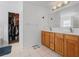 Bright bathroom with a dual vanity sink, closet, and bathtub at 1657 Bradmere Ln, Lithia Springs, GA 30122