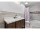 Bathroom vanity featuring stylish dark wood cabinets and a shower with decorative tile accents at 1657 Bradmere Ln, Lithia Springs, GA 30122