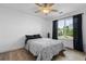 Bedroom featuring light hardwood floors, ceiling fan, and view of the yard through the window at 1657 Bradmere Ln, Lithia Springs, GA 30122