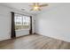 Bright bedroom with large window, stylish ceiling fan, and modern flooring at 1657 Bradmere Ln, Lithia Springs, GA 30122