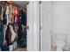 Bedroom closet with many items hanging from the racks, and an adjacent toilet at 1657 Bradmere Ln, Lithia Springs, GA 30122