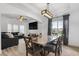 Elegant dining room featuring an open floor plan, modern lighting, and stylish decor at 1657 Bradmere Ln, Lithia Springs, GA 30122
