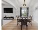 Dining room with modern lighting, table and chairs, open to living area with a window at 1657 Bradmere Ln, Lithia Springs, GA 30122