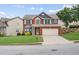 Charming two-story home with brick facade, two-car garage, manicured lawn and inviting curb appeal at 1657 Bradmere Ln, Lithia Springs, GA 30122