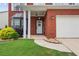 Charming front porch with brick facade, white pillars, and a welcoming front door at 1657 Bradmere Ln, Lithia Springs, GA 30122