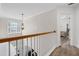 Upstairs hallway features wood floors, white trim, and a decorative light fixture at 1657 Bradmere Ln, Lithia Springs, GA 30122